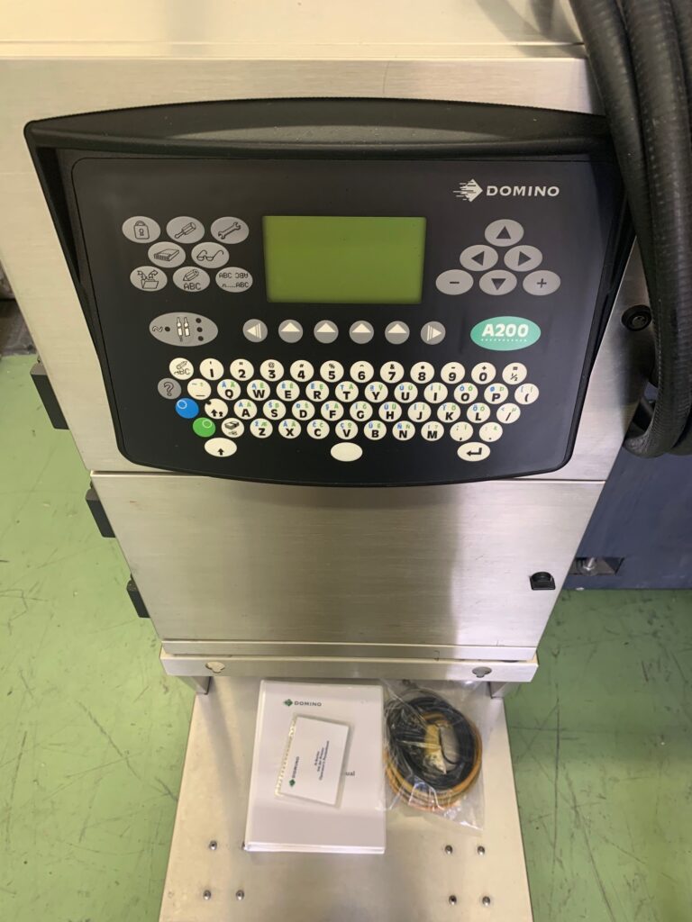 Domino printing machine with a guidebook and wires at the bottom
